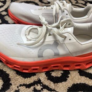 On Running White and Red Athletic Shoes